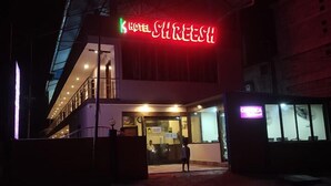 A hotel entrance with a neon sign, a reception desk, and a staircase leading to the upper floor. - HOTEL SHREESH NEIL (Port Blair)