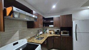 Une cuisine moderne équipée d’une cuisinière, d’un four à micro-ondes et d’un réfrigérateur.