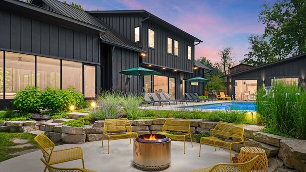 A modern outdoor patio with a fire pit, lounge chairs, and a swimming pool. - Blackwood Shores - 6 bed, pool, hot tub, game room (Lakeside)
