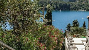 A stone staircase leading to a terrace overlooking a lake with boats and greenery. - Josephine House - Four Bedroom Villa, Sleeps 8 (Kalami)