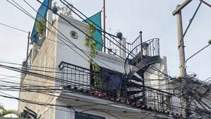 A building with a balcony, a sign for 'Bufete Jurídico', and a closed shuttered door.