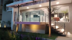 A modern building with a glass facade, a visible staircase, and a sign that reads 'FRANCO'. - Flat pé na areia 406 Branco Haus  (João Pessoa)