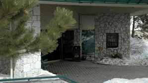 A stone building entrance with a sign reading "The Ridge Club". - Ring in 2026 in South Lake Tahoe in a large, cozy 2 bedroom suite (Stateline)