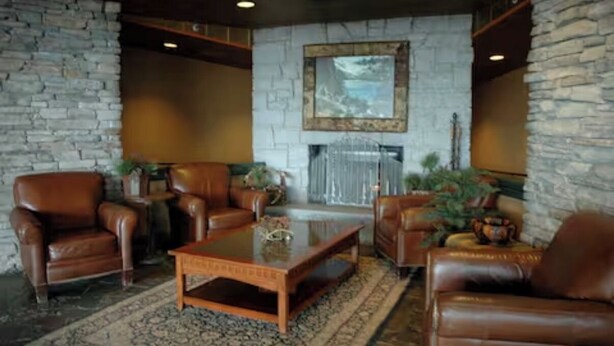 A lobby with stone walls, leather furniture, and a large painting on the wall. - Ring in 2026 in South Lake Tahoe in a large, cozy 2 bedroom suite (Stateline)
