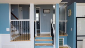 A staircase with a white railing and wooden steps leading to a landing. - Fantastic 4-bedroom Home on Lake Bowen (Inman)