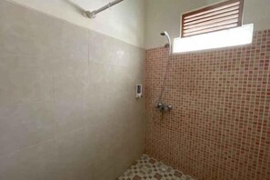 A small, tiled shower room with a window above the shower. - Melati Resort & Hotel Kuta Lombok (Pujut)