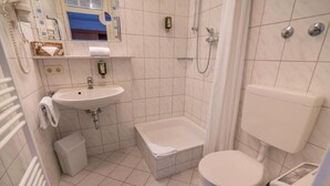 A small, clean bathroom with a sink, toilet, and bathtub. - Residenzhotel Stuttgart Airport, Sure Hotel Collection by BW (Steinenbronn)