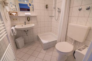 A small, clean bathroom with a sink, toilet, and bathtub. - Residenzhotel Stuttgart Airport, Sure Hotel Collection by BW (Steinenbronn)