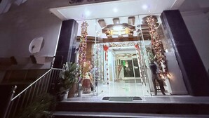 A building with a sign reading "The Sandals Condominium." It features a staircase leading to the entrance, which is decorated with festive ornaments. - The Terrace condominium baguio city (Baguio)