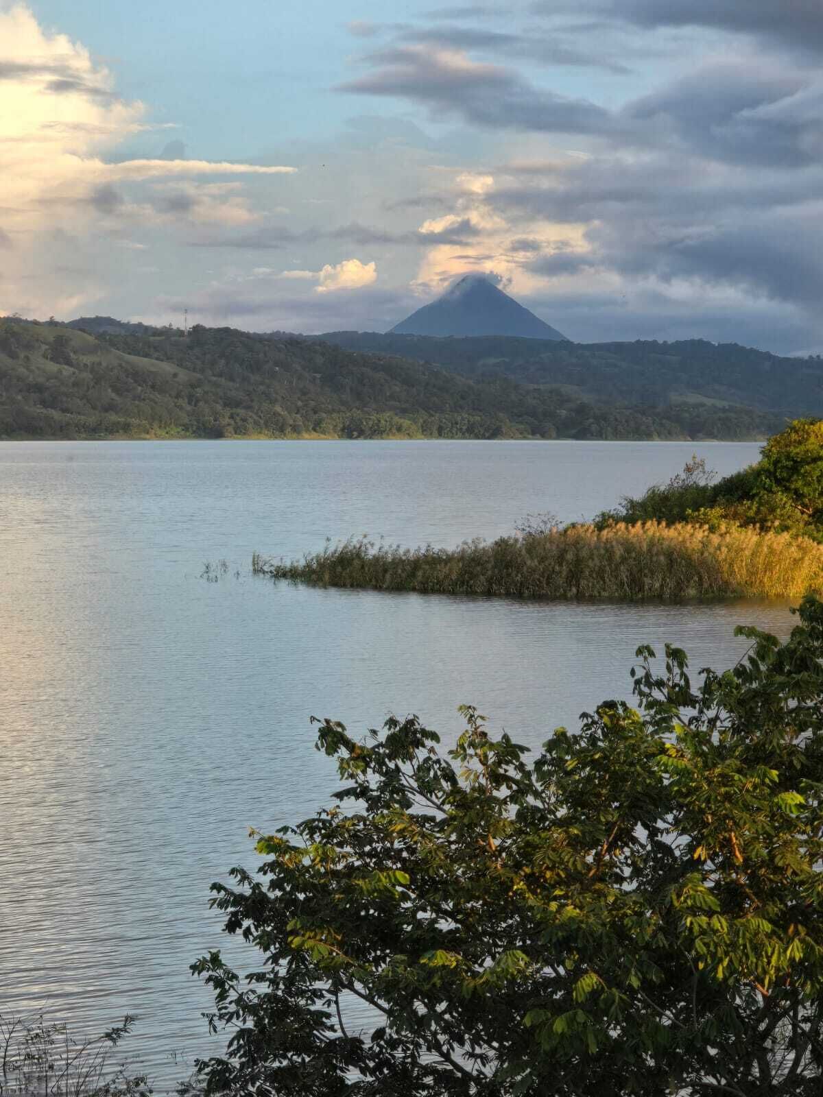 A calm lake with a mountain in the background.