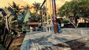 A tropical outdoor area with a wooden deck, rope swings, and palm trees. - Meket Bungalows (Bali)