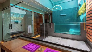 A modern bathroom with a glass-enclosed shower, a wooden vanity, and a large bathtub. - Liv Motel Ecuador (Quito)
