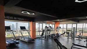 A gym with treadmills, weight machines, and motivational posters. - Marina Bay Suites (Nairobi)