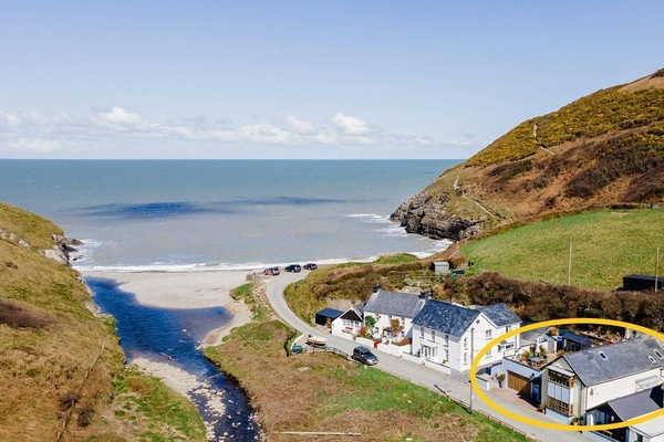 Aerial view of the house, beach and the surrounding properties.