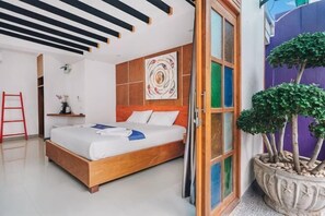 A modern bedroom with a wooden bed, a large window, and a potted plant. - The Villager Fishermans Village (Koh Samui)