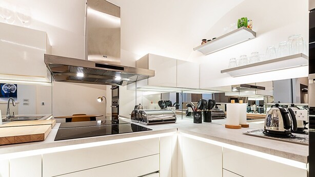 A modern kitchen with a central island, stainless steel appliances, and a built-in oven. - Chic Pimlico Escape with Style & Comfort (London)