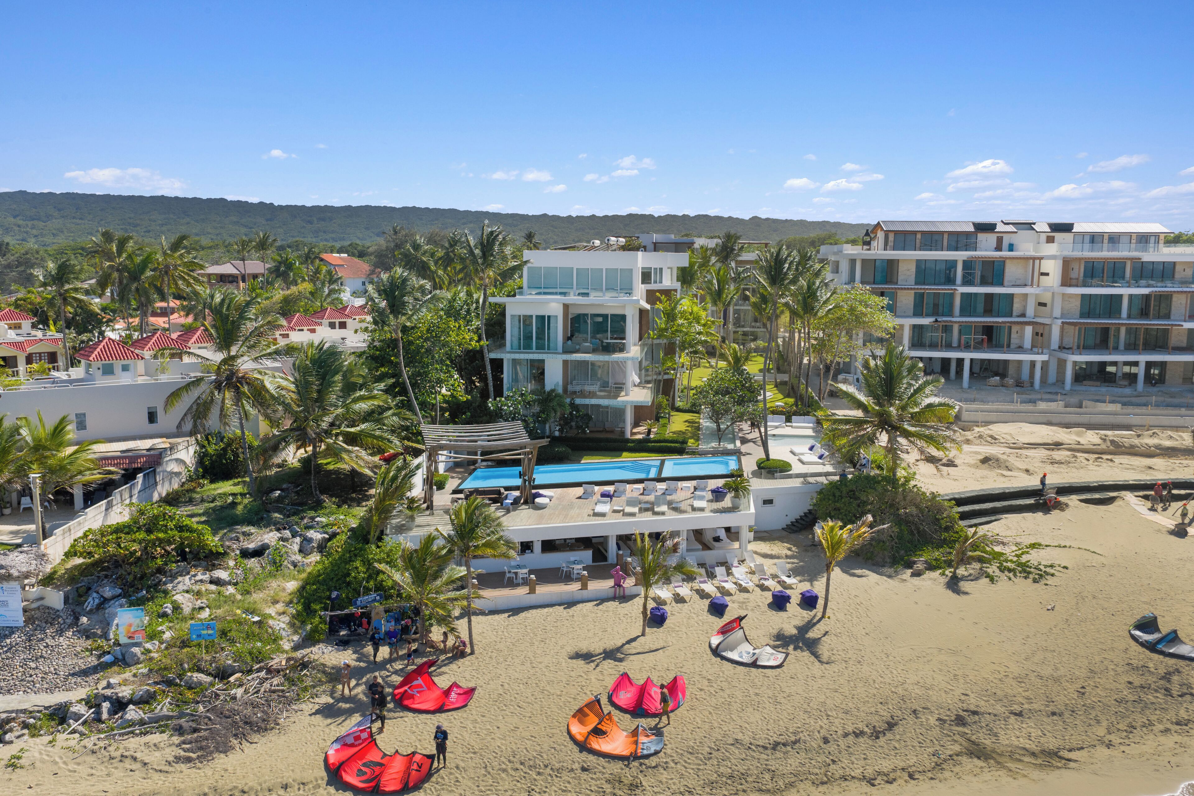A resort with a pool, beach, and multiple buildings.