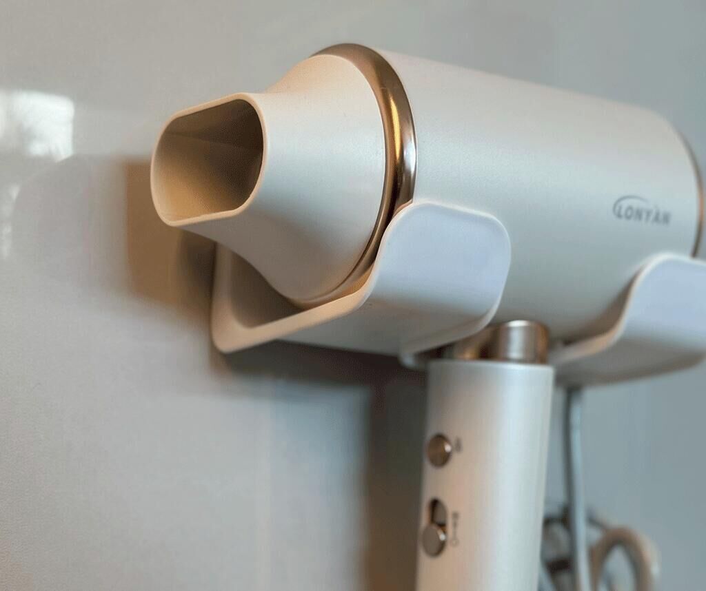 A modern, compact hair dryer with a sleek design, likely intended for travel or portable use.