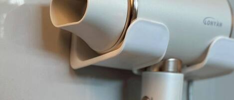 A modern, compact hair dryer with a sleek design, likely intended for travel or portable use.