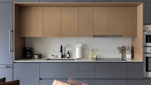 A modern kitchen with grey cabinets, a wooden countertop, and stainless steel appliances. - Resort Style Property 2B/2B walk to Everything! (Cleveland)