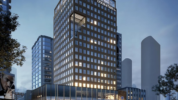 A modern hotel with a prominent 'DoubleTree' sign, large windows, and a glass facade. - Doubletree By Hilton Auckland Albert Street (Auckland)