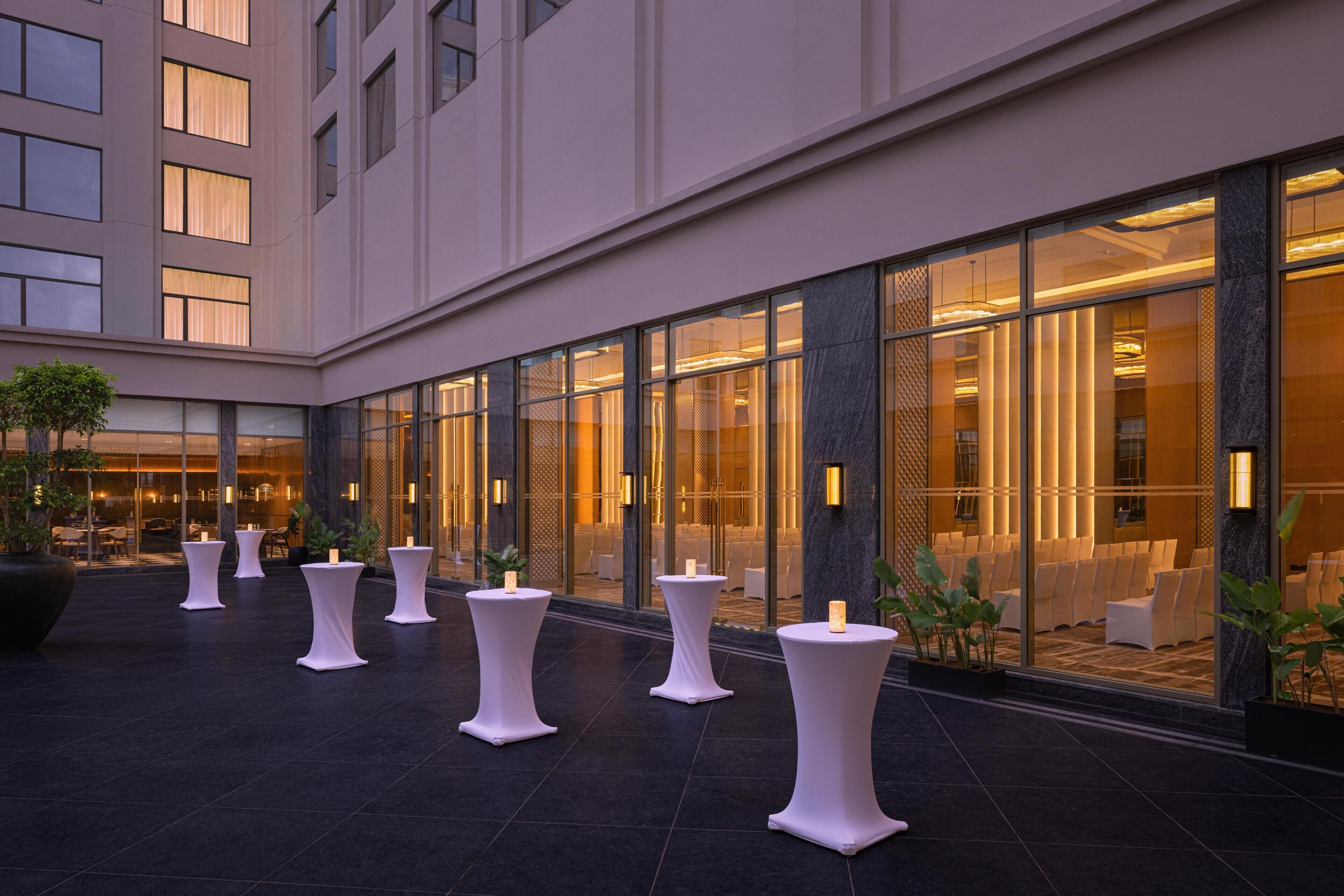 A hotel lobby with a seating area, large windows, and a modern design.
