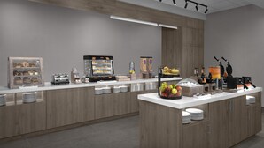 A modern breakfast bar with a coffee machine, waffle maker, and fruit display.