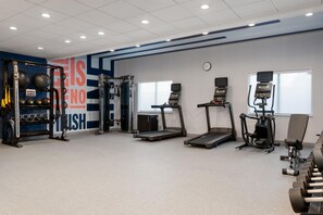 A gym with treadmills, weight machines, and free weights. - Hampton Inn & Suites Cadillac (Cadillac)
