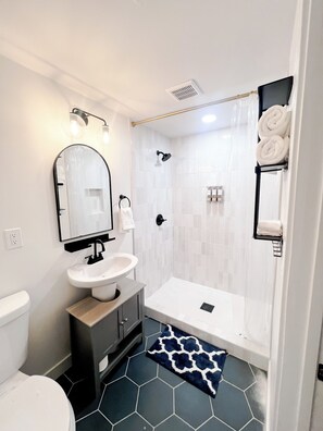 Shower, hair dryer, towels, soap