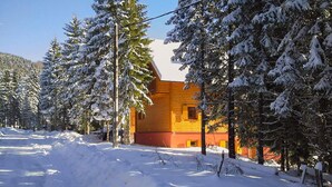 A wooden cabin surrounded by snow-covered trees. - 2 bedroom nice apartment in Mrkopalj (Mrkopalj)