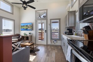 A modern kitchen with a built-in oven, a coffee maker, and a knife block. - Texas Bluebonnet Haus (Fredericksburg)