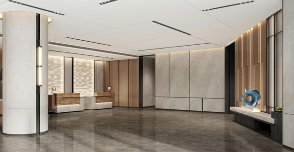Una hall moderna con reception, area salotto e parete decorativa.