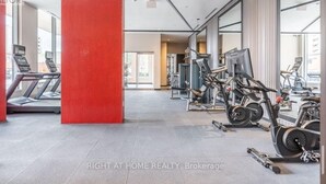 A gym with treadmills, stationary bikes, and weight machines.