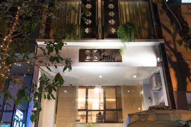 Een hotel met een moderne gevel, grote ramen en een bord waarop staat dat het een hotel is.