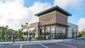 A Panera Bread store with a modern design, large windows, and a parking lot in front. - Hideaway Gem near Disney & golf. Top floor bonus (Davenport)