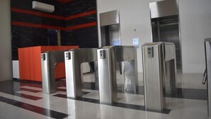 A modern lobby with a check-in counter, a metallic floor, and a large black and red wall. - G Square Residences (Manila)
