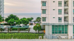 A high-rise building with multiple balconies and a view of the sea. - Great Choice And Homey Studio Apartment At Tokyo Riverside Pik 2 (Teluknaga)