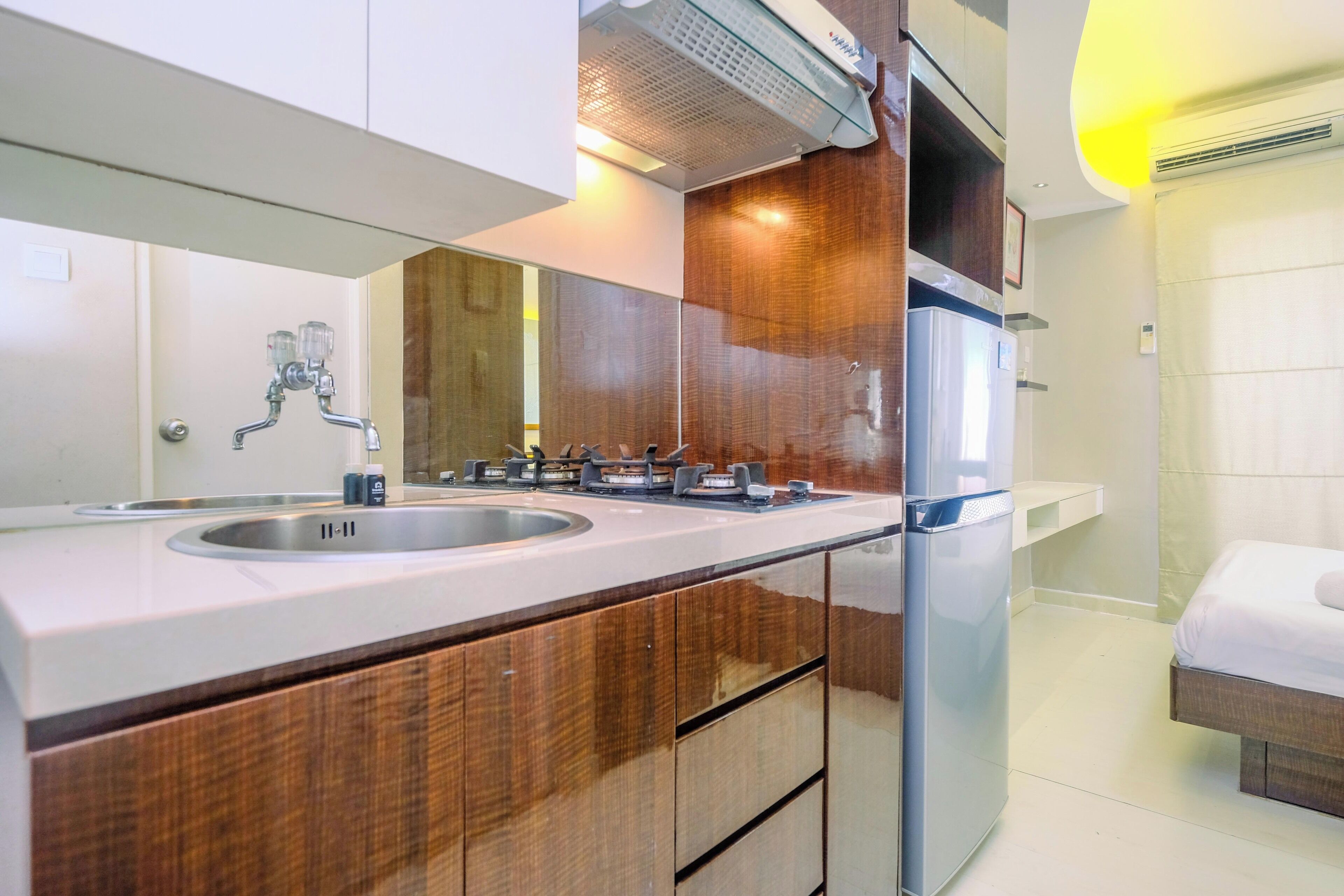 A modern bathroom with a double sink, wooden cabinetry, a mirror, and a built-in heater.