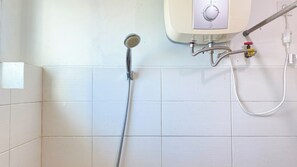 A shower with a handheld showerhead and a wall-mounted control panel. - Good Location And Cozy 2Br Woodland Park Residence Apartment (Jakarta)