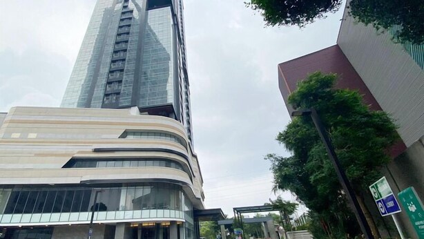 A modern building with a curved facade and large windows. - 1Br Near Mall At Grand Sungkono Lagoon Apartment (Surabaya)