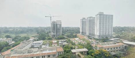 A residential area with high-rise buildings, a construction site, and a parking lot.