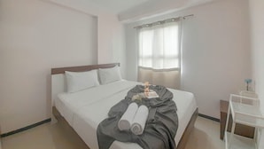 A hotel room with a bed, a bedside table, and a window with curtains. - Basic 2Br At Gateway Pasteur Apartment (Cimahi)