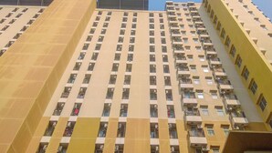 A high-rise building with multiple balconies and a clear sky. - Basic Studio Near Station At Margonda Residence 2 Apartment (Depok)
