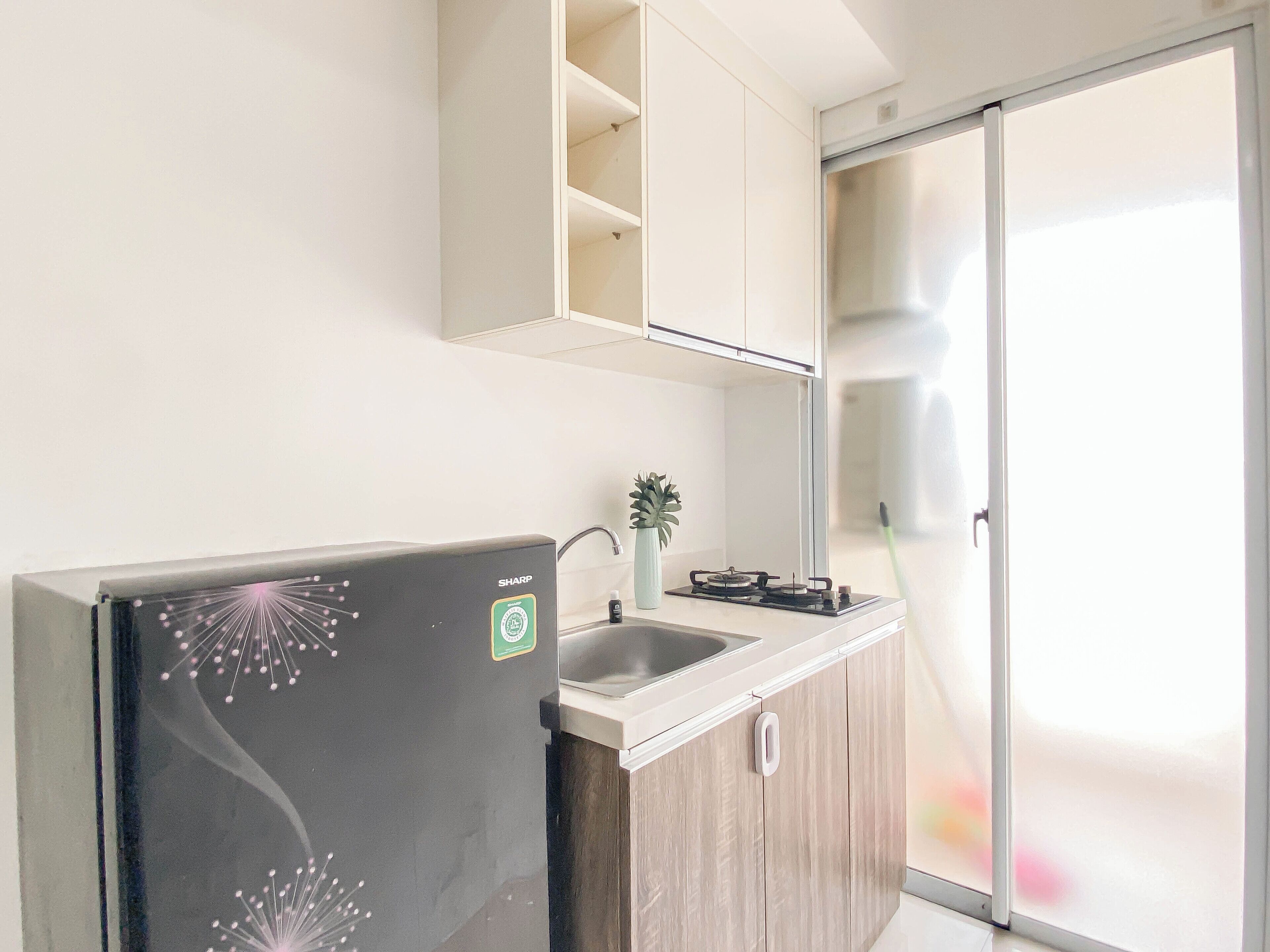 A modern kitchen with a built-in refrigerator, a sink, and a stove.