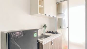 A modern kitchen with a built-in refrigerator, a sink, and a stove.