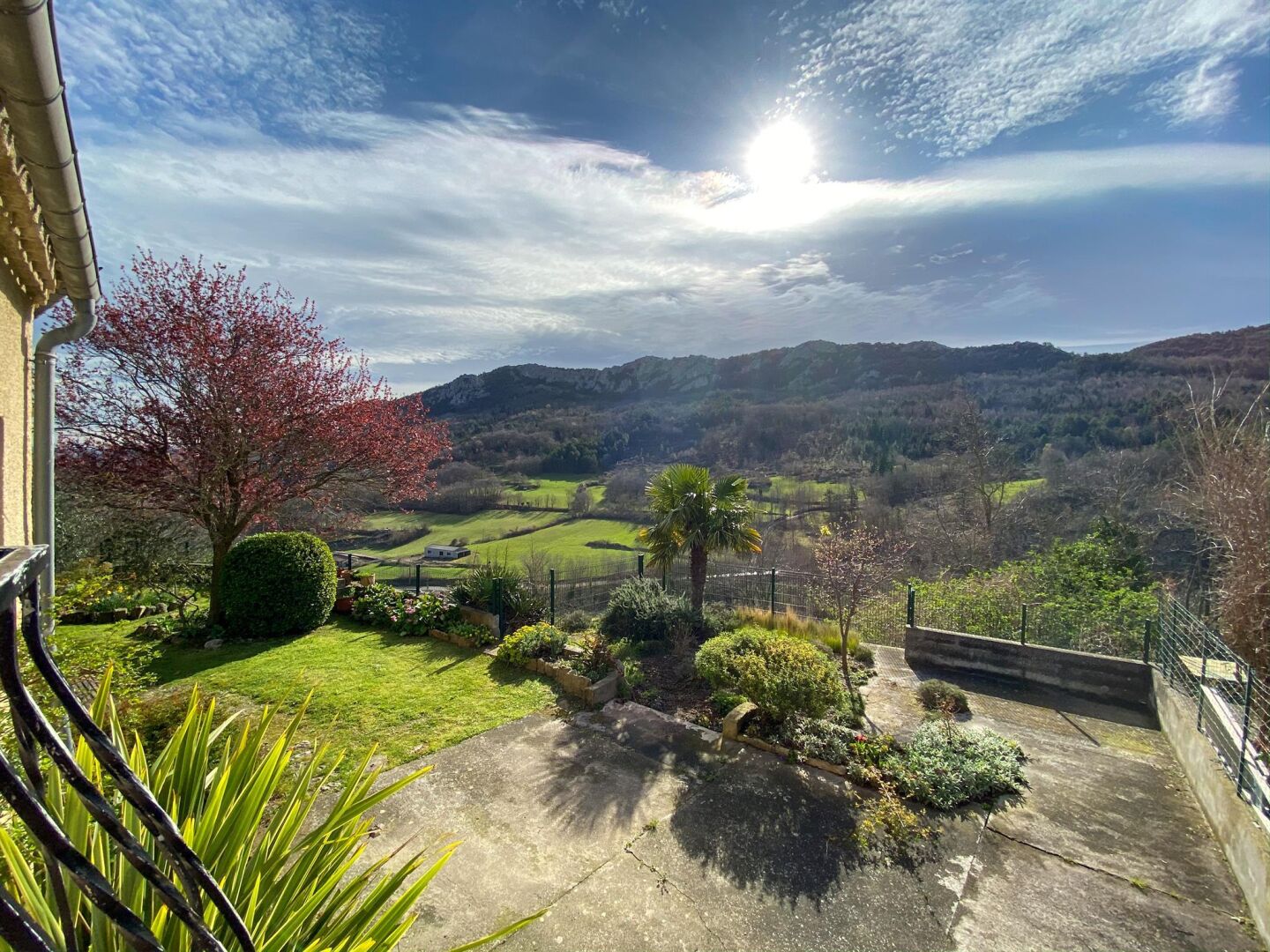 A residential property with a view of rolling hills and a clear sky.