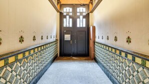 A hallway with patterned tiles, a double door, and a handrail. - Gran Via City Center Apartment (Barcelona)
