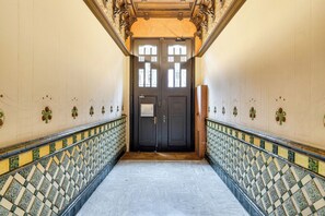 A hallway with patterned tiles, a double door, and a handrail. - Gran Via City Center Apartment (Barcelona)
