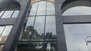 A high-rise building with multiple floors, large windows, and balconies. - RYO 74B 7TH FLOOR VIP (Medellín)