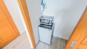 A compact kitchenette with a microwave and refrigerator. - Beachside Retreat with Pool - Sleeps 4 (San Juan)